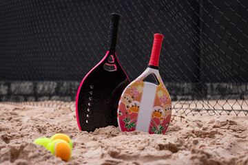 Beach Tennis Kids. Women's beach tennis rackets on the sand. Family beach tennis. Mother and daughter at beach tennis. Copy space