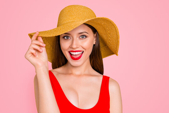 Closeup photo portrait of cheerful cool joyful excited amazed astonished beautiful girl with stylish make-up touching wide brim on trendy hat laughing at camera isolated vivid background