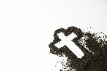 front view of cross shape with dark soil on white desk grim reaper funeral death devil