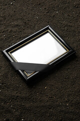 front view of picture frame on dark soil grim reaper funeral death portrait photo