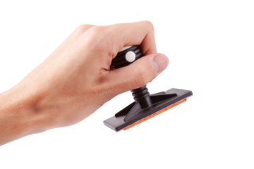 Man holding a modern professional legal office rubber stamp about to stamp sign a document, hand isolated on white, cut out. Accepting, authorizing, stamping a document, corporate decision concept