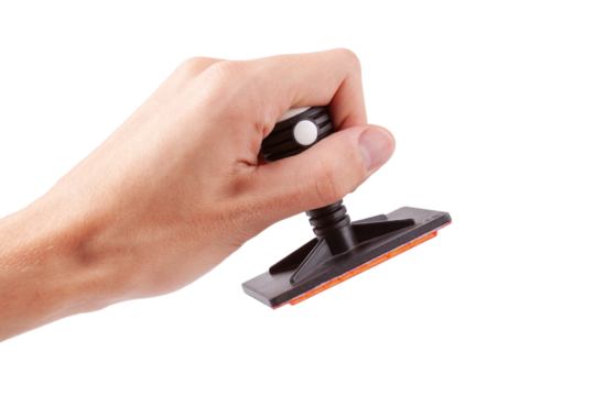 Man holding a modern professional legal office rubber stamp about to stamp sign a document, hand isolated on white, cut out. Accepting, authorizing, stamping a document, corporate decision concept