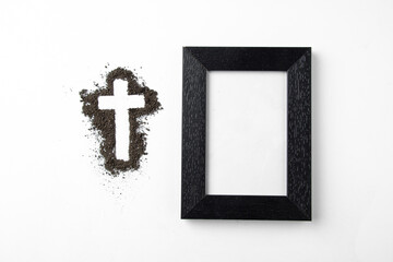 top view cross shape with picture frame white surface soil grim reaper death