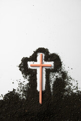 top view stick cross with dark soil on white desk funeral death grim reaper