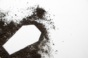 top view of coffin shape with dark soil on white desk grim reaper funeral death