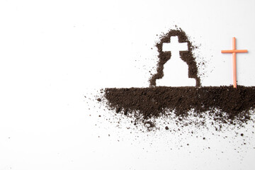 top view of cross shape with dark soil on a white surface death funeral grim reaper