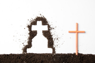 top view of cross shape with dark soil on white floor grim reaper death funeral
