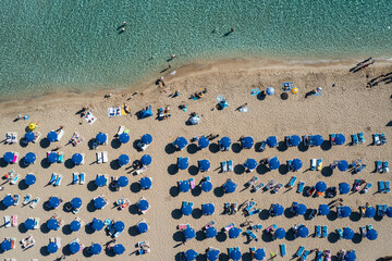 Drone photo of parasols on Fig Tree beach in Protaras tourist resort, Paralimni Municipality, Cyprus