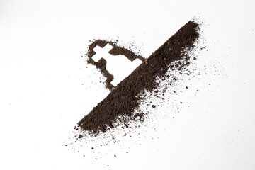 top view of cross shape with dark soil on white surface grim reaper death funeral