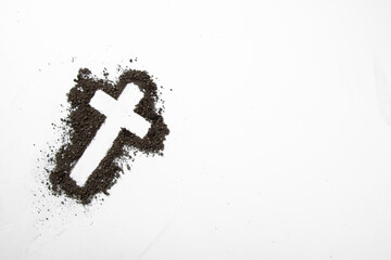 top view of cross shape with dark soil on white surface soil grim reaper funeral