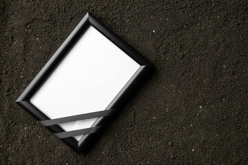 top view of picture frame on a dark soil grim reaper death portrait photo funeral