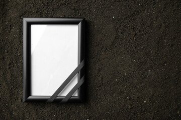 top view of picture frame on dark soil grim reaper death portrait photo funeral