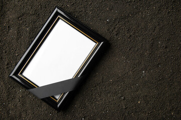 top view of picture frame on the dark soil grim reaper funeral death photo portrait