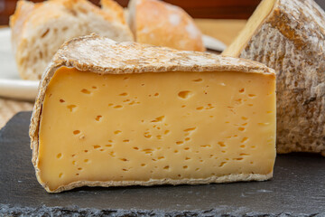 Pieces of cheese tomme de montagne or tomme de savoie made from cow milk in French Alps close up
