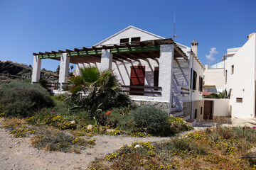 Fototapeta na wymiar Whitewashed houses by the shore in Cabo de Palos village