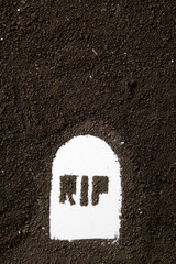 top view of rip inscription on grave shape with dark soil grim reaper death funeral