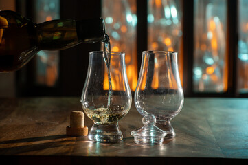 Pouring in tulip-shaped tasting glass Scotch single malt or blended whisky