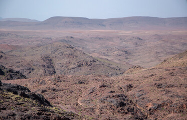 Desert landscapes in Morocco, desolate lands with paths that lead to remote and unexplored corners. Climate change and arid climate. Desertification and lack of water. Mountains and hills