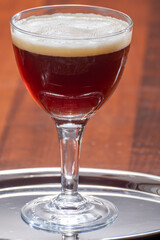 Glass of Belgian abbey brown beer in bar