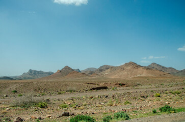 Desert landscapes in Morocco, desolate lands with paths that lead to remote and unexplored corners. Climate change and arid climate. Desertification and lack of water. Mountains and hills