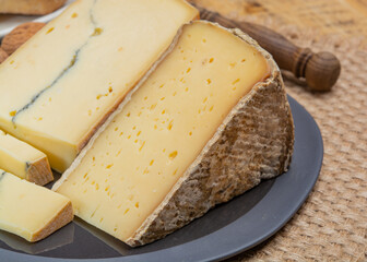 Cheese collection, French cheeses Morbier semi-soft cow milk cheese with black mold layer and Tomme de Savoie with grey rind