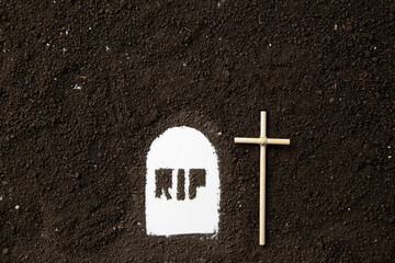 top view of rip inscription with dark soil death grim reaper funeral devil