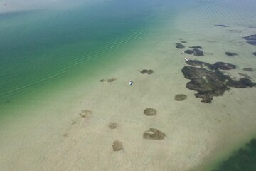 An aerial drone view of Caladesi Island, Dunedin, Florida, beautiful white beaches, and blue, green waters of the Gulf of Mexico.