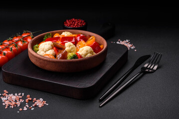 Delicious salad of fresh cherry tomatoes, sweet peppers, broccoli and cauliflower