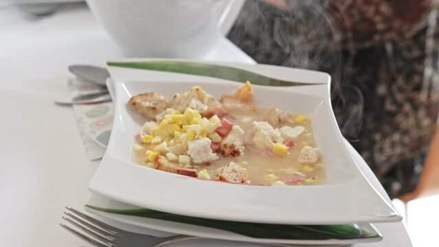 Pouring Steaming Traditional Polish Hot Sour Rye Soup into Plate for People Eating Dinner during Easter Holiday Family Gathering