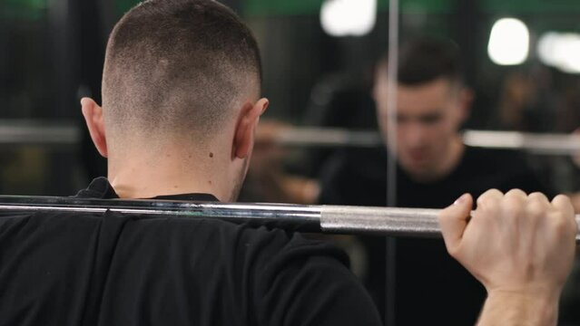 Squat Technique, Leg Workouts, Muscle Growth. Bodybuilder Demonstrates Intense Masculine Strength By Performing Barbell Squats With Weights Placed On Neck, Embodying Commitment To Healthful Lifestyle