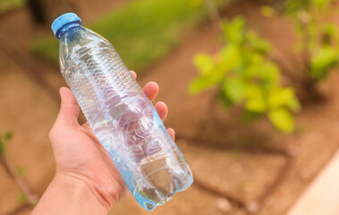 plastic bottles scattered around the pool and beach represent the negative impact of human activity on the environment. The pollution caused by single-use plastic bottles affects the ocean