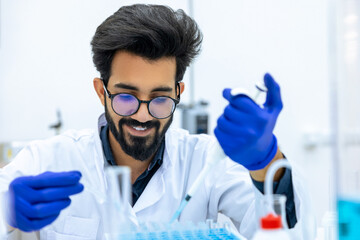 Man scientist dripping chemicals to test tubes, biochemist conducting experiments to discover drugs