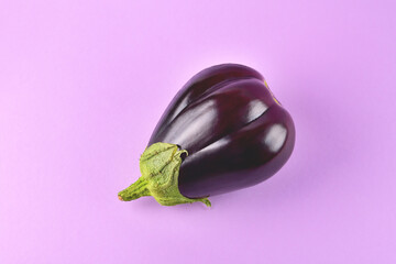 Eggplant on a purple background, fresh juicy vegetable on a colored background, selective focus, soft focus, close-up