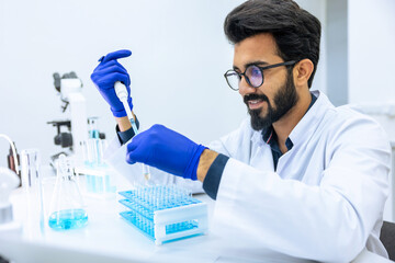 Man scientist dripping chemicals to test tubes, biochemist conducting experiments to discover drugs