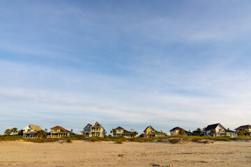 Beach vacation homes on the sand shoreline