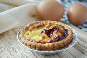 a egg tart on a wooden board