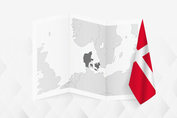 Fototapeta na wymiar A grayscale map of Denmark with a hanging Danish flag on one side. Vector map for many types of news.