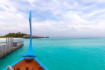  take a boat ride to a tropical island in the Maldives