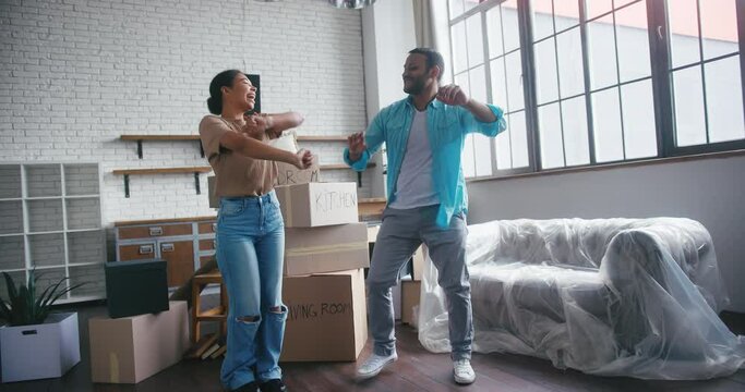 Married couple dances together celebrating house purchase