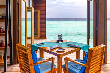 table and chairs on the terrace overlooking the Maldives atoll