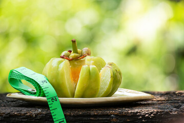 Garcinia atroviridis an tape measure on nature background.