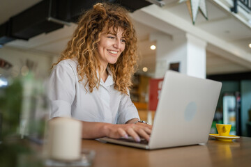 Woman use work on laptop from cafe happy smile adult caucasian