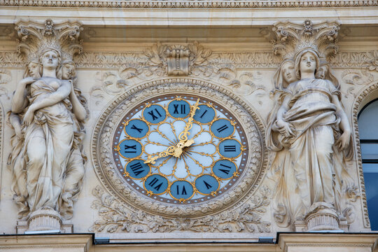 Giant clock on the facade of a building in Paris .