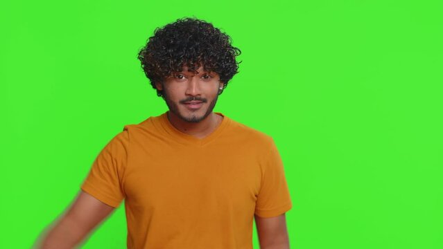 Ambitious satisfied egoistic young indian man winner of lottery posing for photographers, successful famous rich person. Celebrating success, winning. Hindu guy isolated on green chroma key background