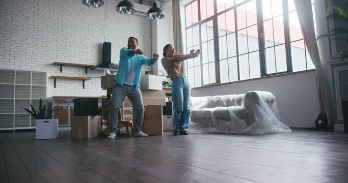 Married couple dances together celebrating house purchase