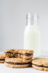 oat cookies with chocolate filling, homemade oatmeal cookies filled with chocolate ganache, thin oat biscuits with chocolate ganache