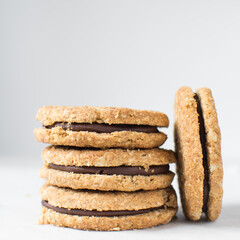 oat cookies with chocolate filling, homemade oatmeal cookies filled with chocolate ganache, thin oat biscuits with chocolate ganache
