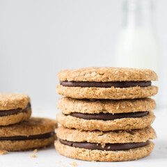 oat cookies with chocolate filling, homemade oatmeal cookies filled with chocolate ganache, thin oat biscuits with chocolate ganache