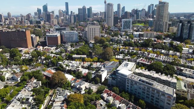 Aerial drone view of streets and houses in Paddington looking toward Darlinghurst in East Sydney, NSW Australia with Sydney City in the background on a sunny day
