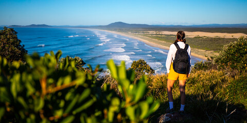 beautiful backpacker girl enjoying spectacular view of new south wales coast in hat head national...